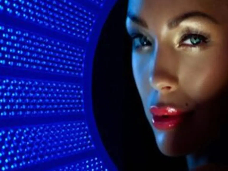 Blue LED side face A woman with blue light shining on her face.