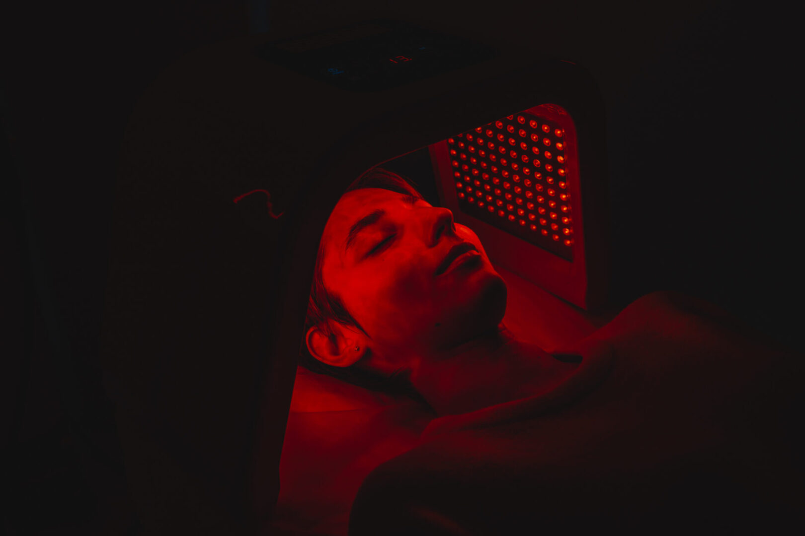 Facial skin care using an LED lamp in a beauty salon. LED Skin Care Spa