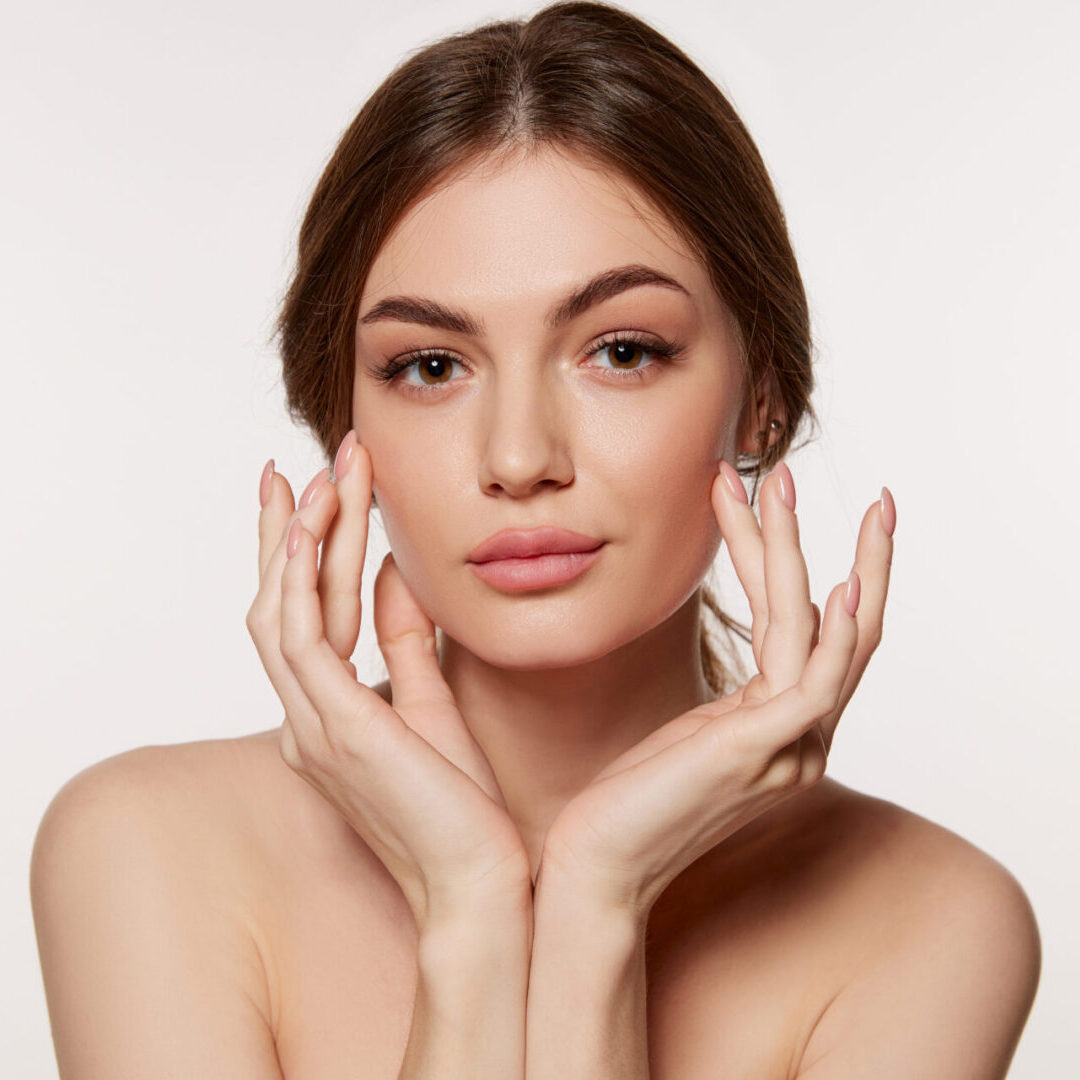 Portrait of young beautiful woman with perfect smooth skin isolated over white background. Perfect face, taking care after skin condition LED Skin Care Spa