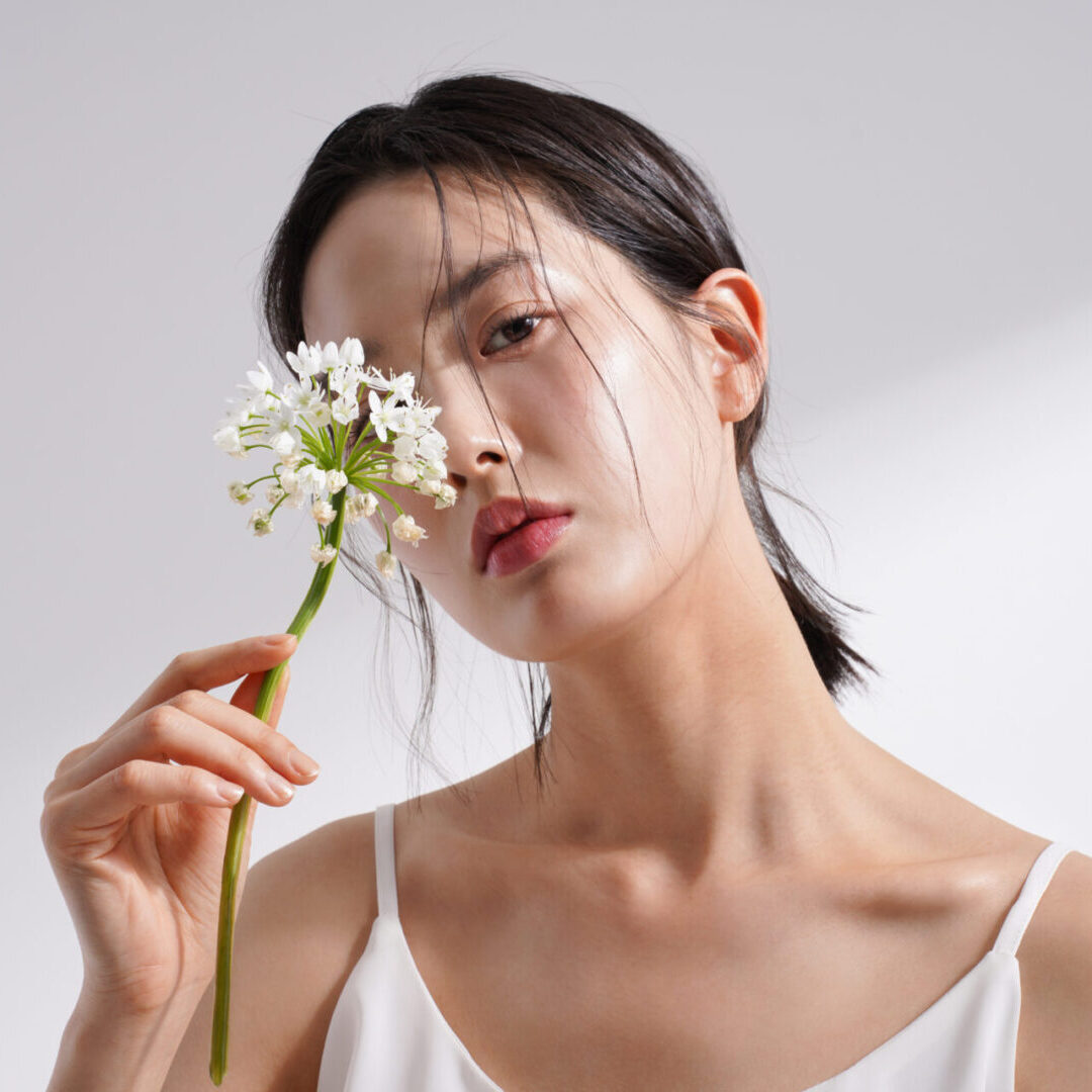 Beauty image of a young Korean woman photographed against a background of light and shadow LED Skin Care Spa