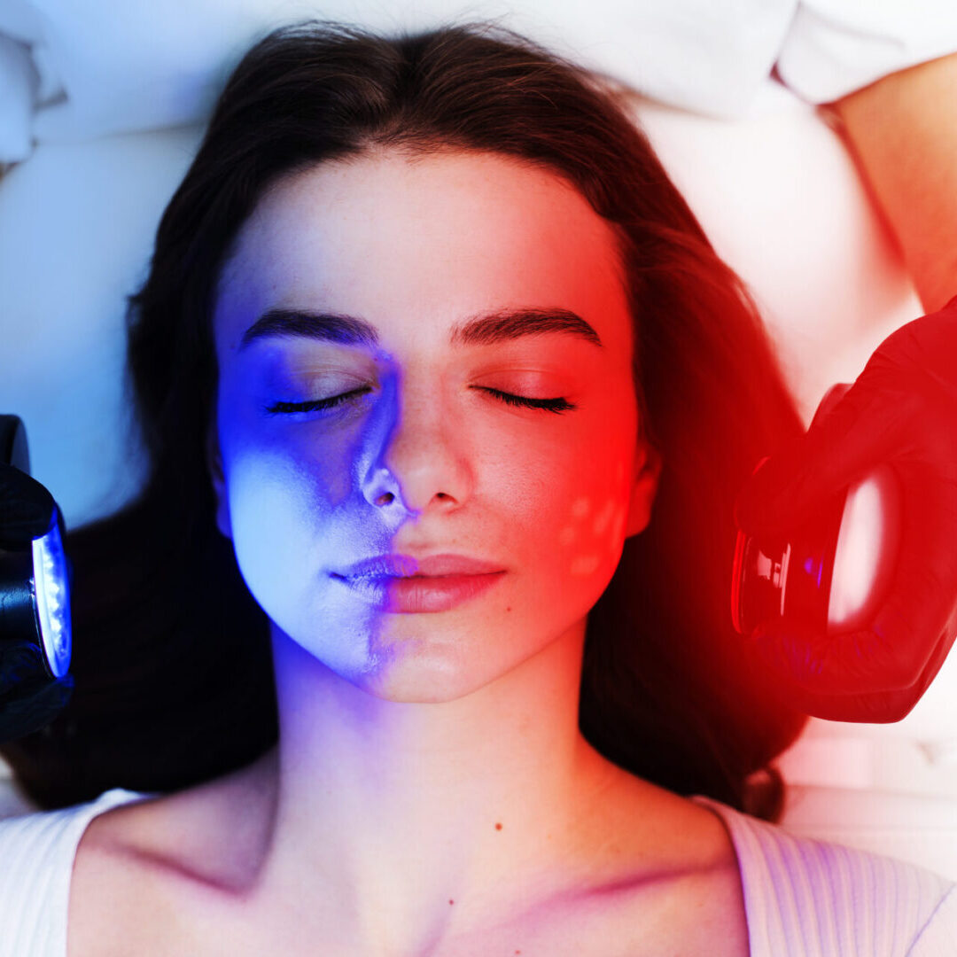 LED light skin treatment. Hydradermabrasian skincare procedure to moisturizing skin for young woman. Red and Blue light at cosmetology procedure. LED Skin Care Spa